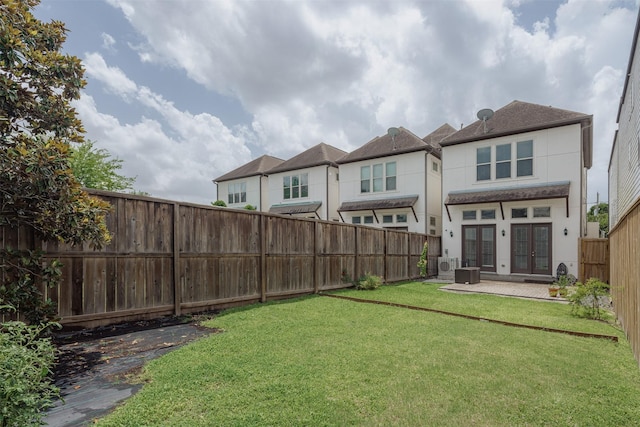1207 W 25th St, Houston, TX 77008 - back of house with french doors, a fenced backyard, stucco siding, and a patio