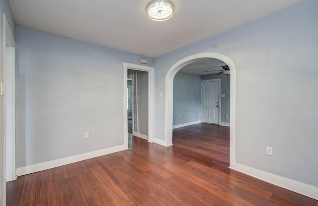 1117 Elliston St, Houston, TX 77023 - spare room featuring arched walkways, wood finished floors, and a ceiling fan
