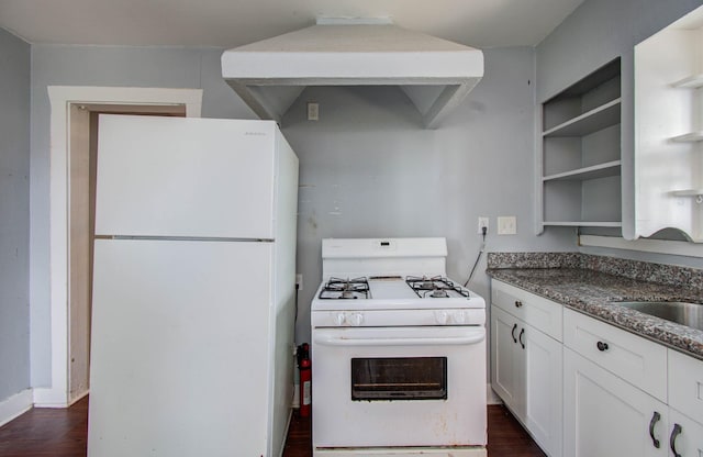 1117 Elliston St, Houston, TX 77023 - kitchen with white appliances, open shelves, dark wood-style floors, and white cabinets