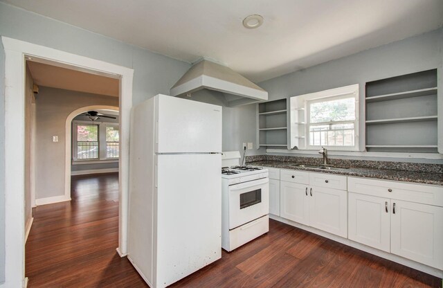 1117 Elliston St, Houston, TX 77023 - kitchen featuring white appliances, open shelves, custom range hood, and dark wood-style floors