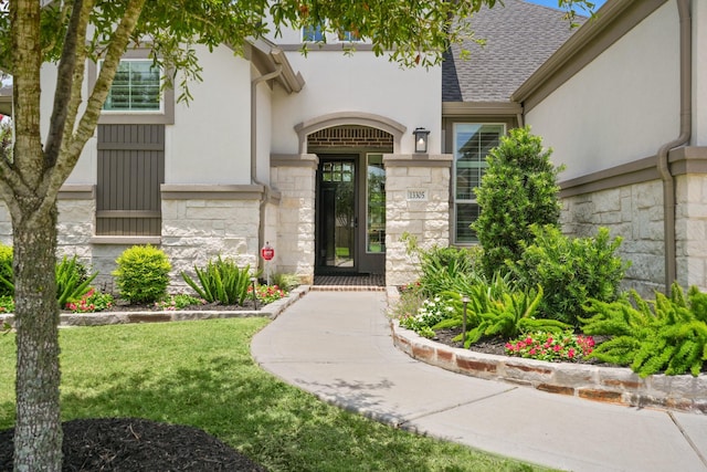 13305 Newcastle Creek Ct, Houston, TX 77059 - entrance to property with stone siding, stucco siding, a yard, and roof with shingles