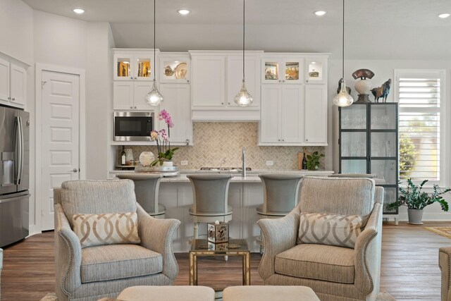 13305 Newcastle Creek Ct, Houston, TX 77059 - kitchen featuring stainless steel appliances, white cabinets, backsplash, glass insert cabinets, and recessed lighting