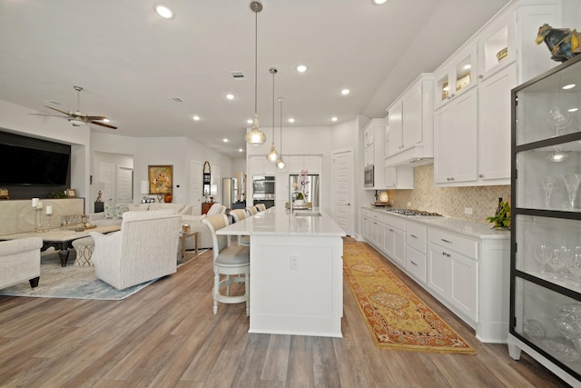 13305 Newcastle Creek Ct, Houston, TX 77059 - kitchen with open floor plan, recessed lighting, backsplash, ceiling fan, and white cabinets