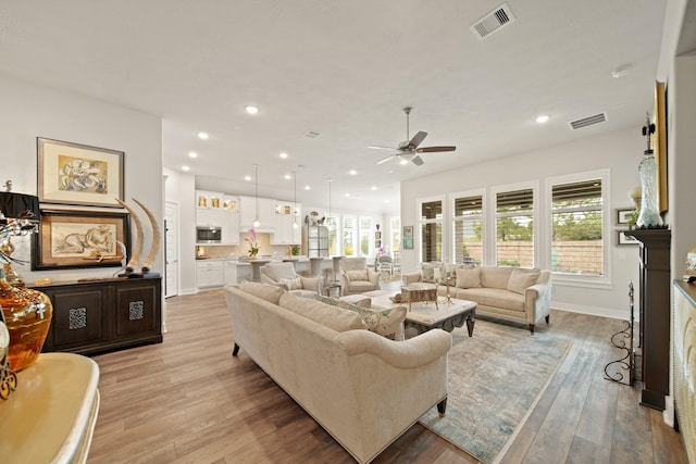 13305 Newcastle Creek Ct, Houston, TX 77059 - living area featuring a ceiling fan, light wood-style floors, and recessed lighting