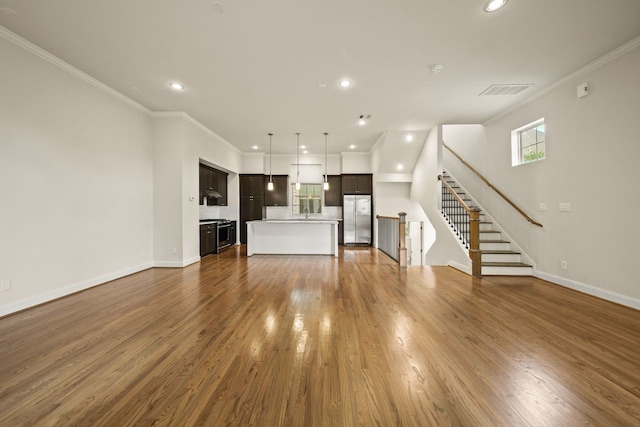 1034 W 26th St Unit D, Houston, TX 77008 - unfurnished living room featuring recessed lighting, crown molding, wood finished floors, and stairs