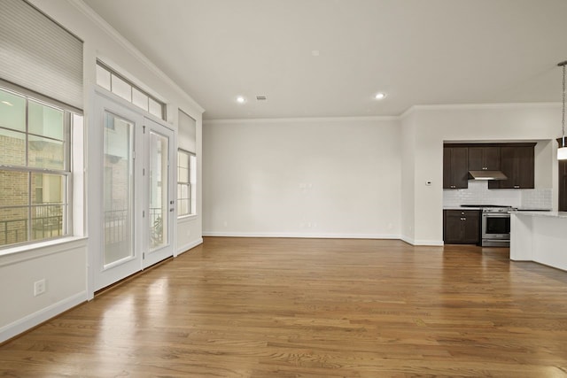 1034 W 26th St Unit D, Houston, TX 77008 - unfurnished living room with plenty of natural light, crown molding, recessed lighting, and wood finished floors