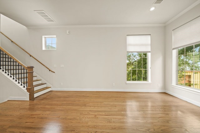 1034 W 26th St Unit D, Houston, TX 77008 - unfurnished living room with healthy amount of natural light, crown molding, stairs, light wood-style flooring, and recessed lighting