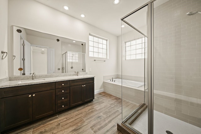 1034 W 26th St Unit D, Houston, TX 77008 - full bathroom with a stall shower, a bath, double vanity, wood finished floors, and recessed lighting