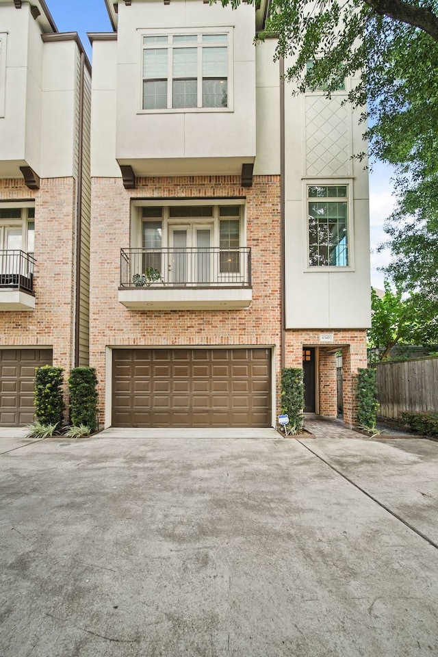 1034 W 26th St Unit D, Houston, TX 77008 - townhome / multi-family property with asphalt driveway, brick siding, and a garage