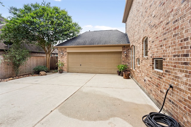 12902 Tamarack Bend Ln, Humble, TX 77346 - view of side of property with brick siding, concrete driveway, a shingled roof, and an attached garage
