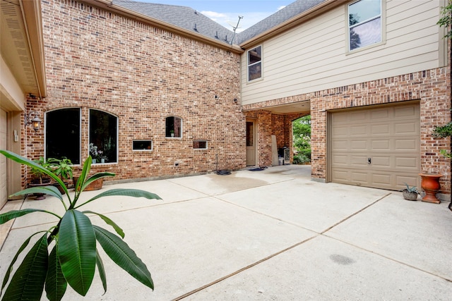 12902 Tamarack Bend Ln, Humble, TX 77346 - view of patio featuring driveway and a garage