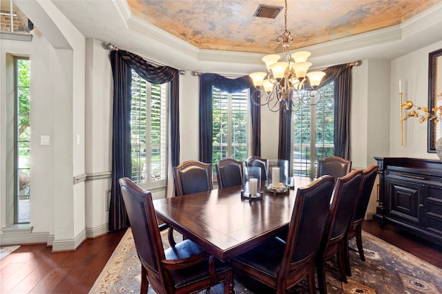 12902 Tamarack Bend Ln, Humble, TX 77346 - dining room featuring a tray ceiling, a chandelier, dark wood finished floors, and crown molding