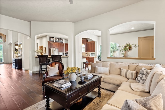 12902 Tamarack Bend Ln, Humble, TX 77346 - living room featuring arched walkways and dark wood-style floors