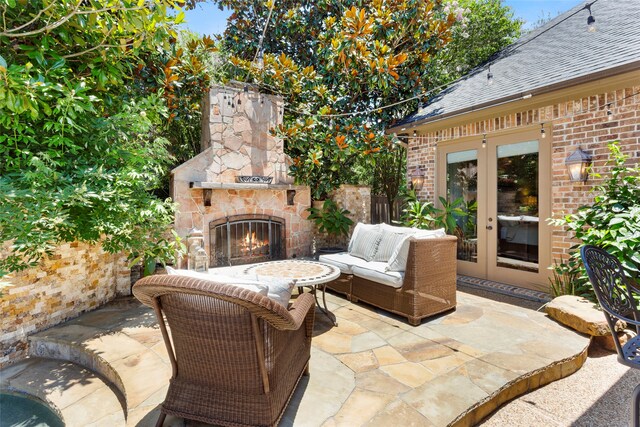 12902 Tamarack Bend Ln, Humble, TX 77346 - view of patio / terrace featuring an outdoor stone fireplace and french doors