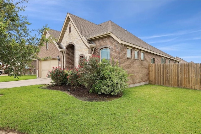 9111 Regan Way, Mont Belvieu, TX 77523 - view of front of property featuring brick siding, roof with shingles, an attached garage, and driveway