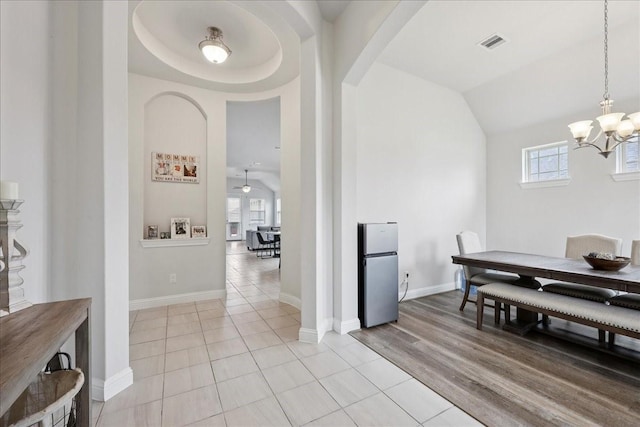 9111 Regan Way, Mont Belvieu, TX 77523 - dining area featuring arched walkways, a chandelier, lofted ceiling, and light tile patterned floors