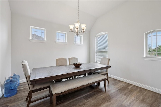 9111 Regan Way, Mont Belvieu, TX 77523 - dining area with wood finished floors, a chandelier, and vaulted ceiling