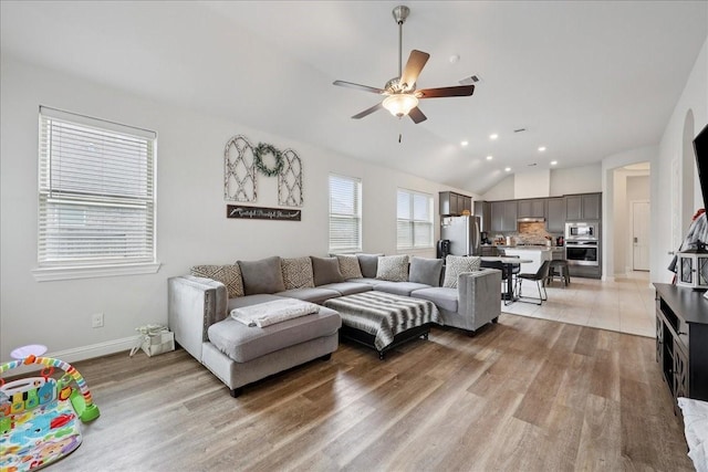 9111 Regan Way, Mont Belvieu, TX 77523 - living area featuring a ceiling fan, lofted ceiling, light wood-type flooring, and recessed lighting