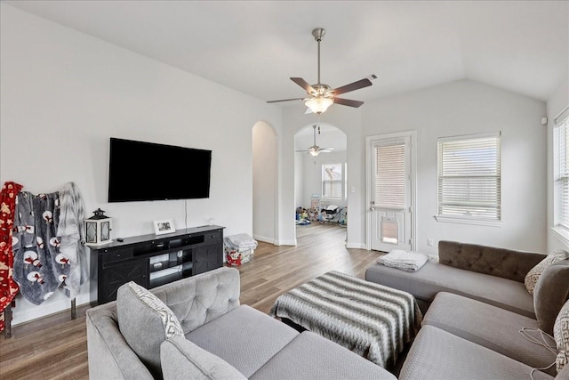 9111 Regan Way, Mont Belvieu, TX 77523 - living area featuring ceiling fan, wood finished floors, vaulted ceiling, and arched walkways