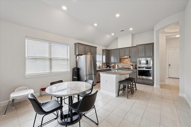9111 Regan Way, Mont Belvieu, TX 77523 - dining area with vaulted ceiling, light tile patterned floors, and recessed lighting