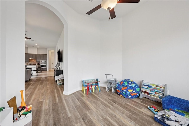 9111 Regan Way, Mont Belvieu, TX 77523 - recreation room with a ceiling fan, wood finished floors, and arched walkways
