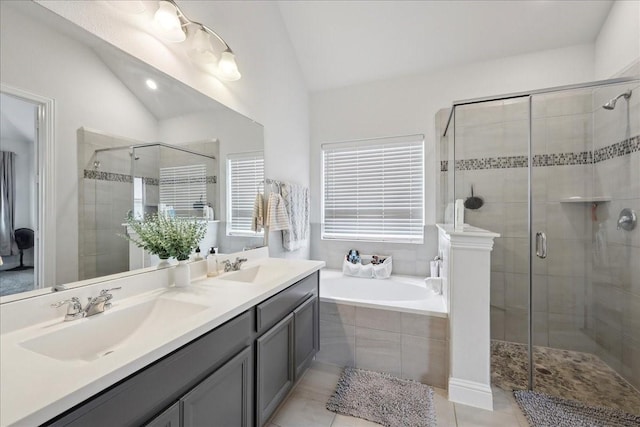 9111 Regan Way, Mont Belvieu, TX 77523 - bathroom with vaulted ceiling, a shower stall, a bath, double vanity, and tile patterned floors
