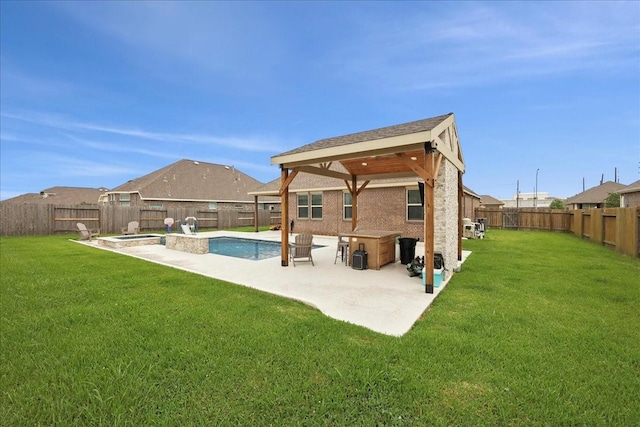 9111 Regan Way, Mont Belvieu, TX 77523 - back of property with a fenced backyard, a patio area, a gazebo, and a pool with connected hot tub