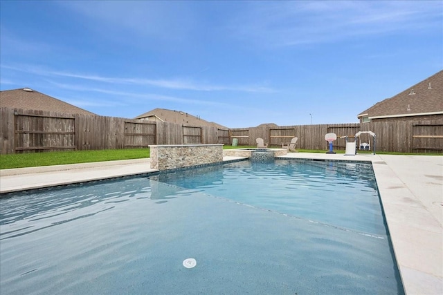 9111 Regan Way, Mont Belvieu, TX 77523 - view of pool with a fenced backyard, a pool with connected hot tub, and a patio