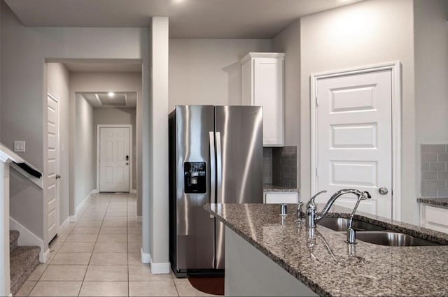 11215 Pavonia Creek Ct, Richmond, TX 77406 - kitchen with stainless steel refrigerator with ice dispenser, white cabinets, light tile patterned flooring, and decorative backsplash