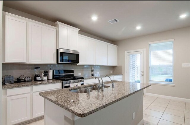 11215 Pavonia Creek Ct, Richmond, TX 77406 - kitchen with appliances with stainless steel finishes, backsplash, a center island with sink, white cabinets, and recessed lighting