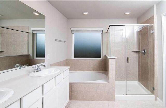 11215 Pavonia Creek Ct, Richmond, TX 77406 - bathroom featuring a garden tub, a shower stall, double vanity, tile patterned floors, and recessed lighting