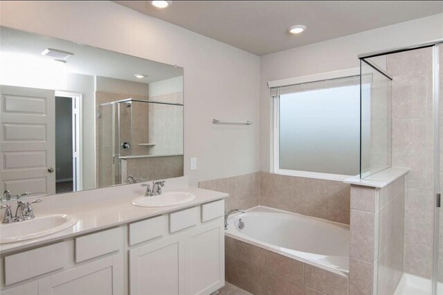 11215 Pavonia Creek Ct, Richmond, TX 77406 - bathroom featuring a shower stall, a bath, double vanity, and recessed lighting