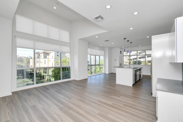 207 Pierce St Unit 301, Houston, TX 77002 - unfurnished living room featuring light wood-style floors and recessed lighting
