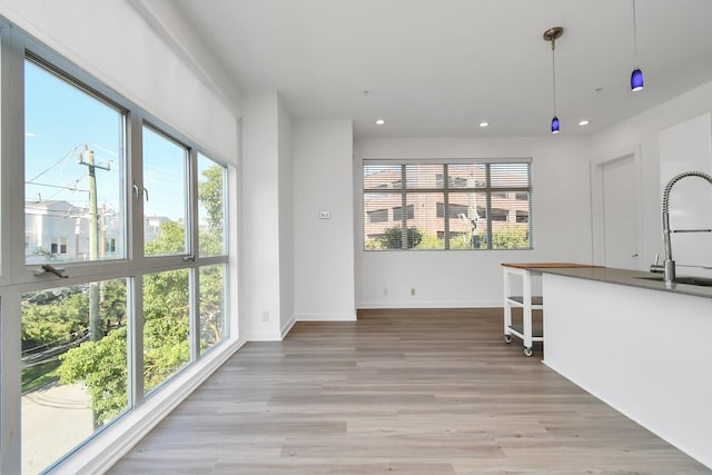 207 Pierce St Unit 301, Houston, TX 77002 - kitchen featuring healthy amount of natural light, light wood-style flooring, recessed lighting, and pendant lighting