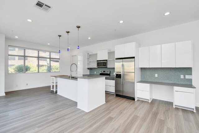 207 Pierce St Unit 301, Houston, TX 77002 - kitchen featuring stainless steel appliances, modern cabinets, light wood-type flooring, white cabinetry, and open shelves
