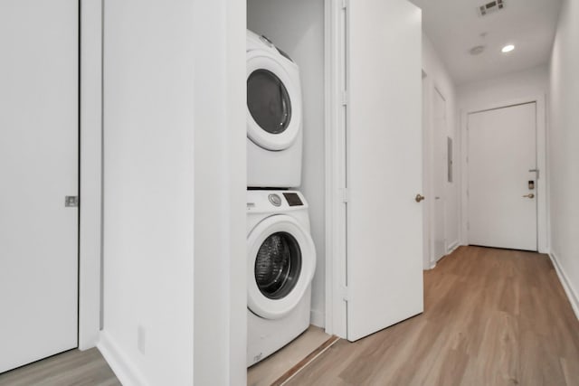 207 Pierce St Unit 301, Houston, TX 77002 - laundry room with stacked washer / dryer and light wood-style floors