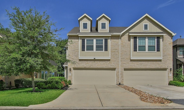 239 Biltmore Loop, Montgomery, TX 77316 - view of front of home with stone siding, a garage, concrete driveway, and board and batten siding