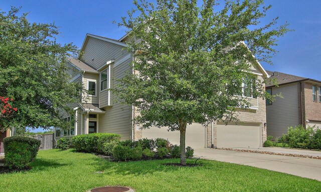 239 Biltmore Loop, Montgomery, TX 77316 - view of front of house featuring an attached garage and concrete driveway