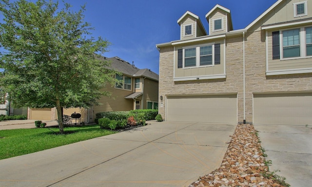 239 Biltmore Loop, Montgomery, TX 77316 - view of front of property with stone siding, an attached garage, driveway, and board and batten siding