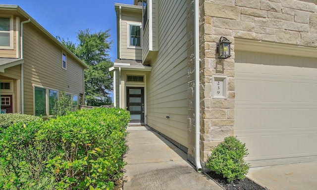 239 Biltmore Loop, Montgomery, TX 77316 - view of exterior entry featuring a garage