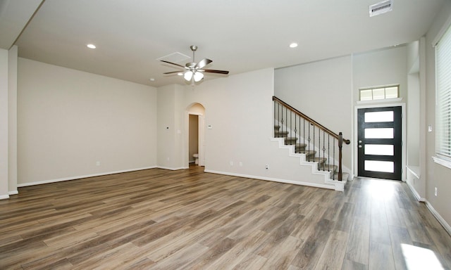 239 Biltmore Loop, Montgomery, TX 77316 - foyer entrance featuring wood finished floors, stairway, arched walkways, ceiling fan, and recessed lighting
