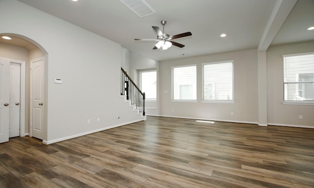 239 Biltmore Loop, Montgomery, TX 77316 - unfurnished living room featuring ceiling fan, wood finished floors, arched walkways, recessed lighting, and stairs