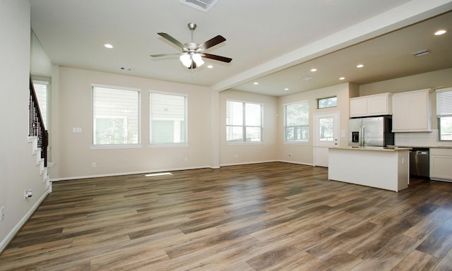239 Biltmore Loop, Montgomery, TX 77316 - unfurnished living room with dark wood-type flooring, a ceiling fan, recessed lighting, stairway, and beam ceiling