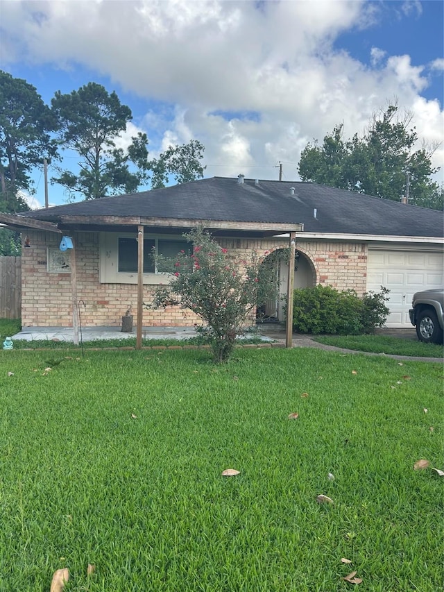 1818 Hillshire Dr, Deer Park, TX 77536 - rear view of house with brick siding, a lawn, and an attached garage
