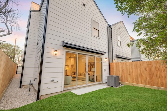 1609 Park St, Houston, TX 77019 - back of house at dusk with a fenced backyard