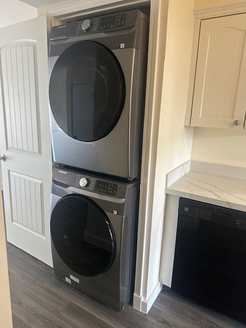 2308 Winrock Blvd Unit 173, Houston, TX 77057 - laundry room with stacked washer / drying machine and dark wood-type flooring