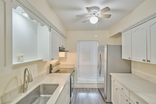 2308 Winrock Blvd Unit 173, Houston, TX 77057 - kitchen with appliances with stainless steel finishes, a ceiling fan, under cabinet range hood, light stone countertops, and white cabinets