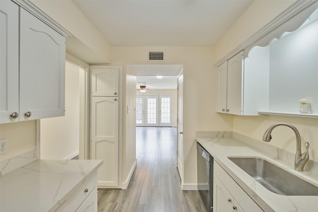 2308 Winrock Blvd Unit 173, Houston, TX 77057 - kitchen featuring stainless steel dishwasher, ceiling fan, light wood-style floors, white cabinets, and light stone countertops