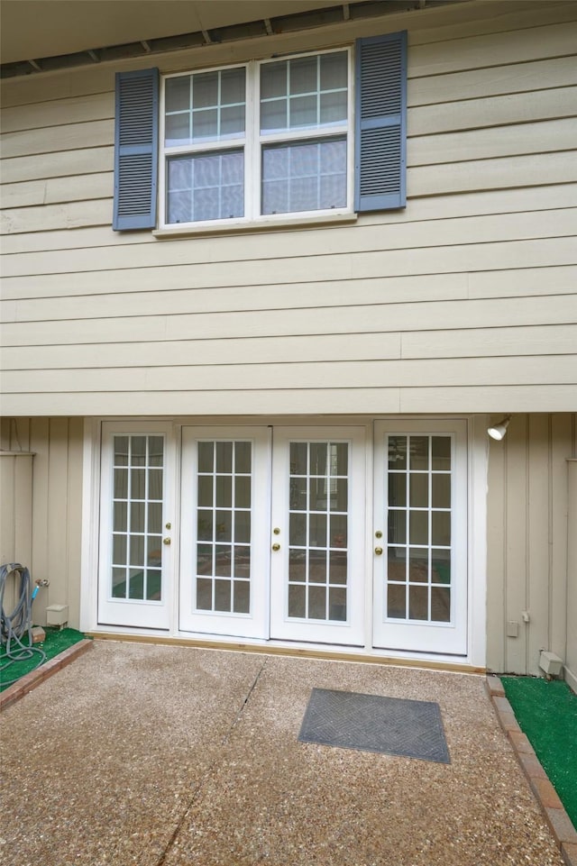 2308 Winrock Blvd Unit 173, Houston, TX 77057 - view of exterior entry featuring french doors, board and batten siding, and a patio