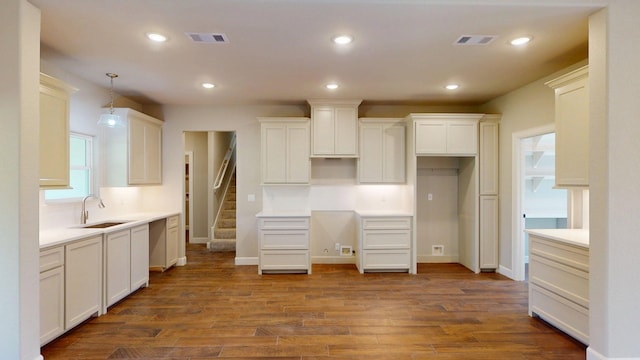 58 Lantana Ct, Lake Jackson, TX 77566 - kitchen featuring dark wood-style flooring, recessed lighting, hanging light fixtures, and white cabinets